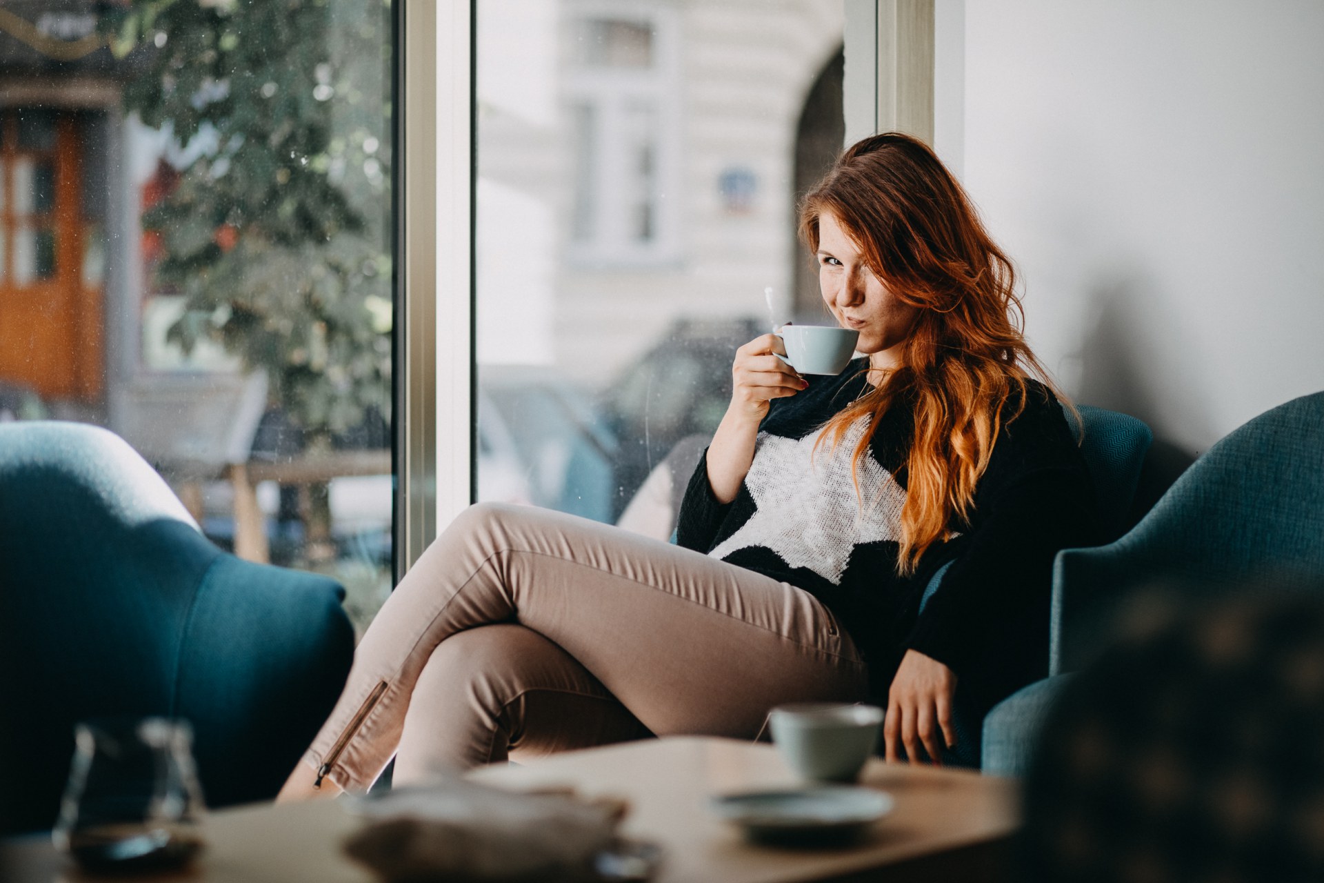 A girl sipping coffee at the cafe